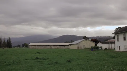 Rustic Farm Field with House, Barn, Greenhouse Establishing Shot, HD 1080p Stock Footage 86885995