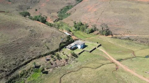 Rustic Farm Nestled in a Verdant Valley: Drone 4K RAW Stock Footage 266972046