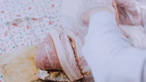 Rustic finished dish: weaving bacon over the pork roll Stock Footage 342184758