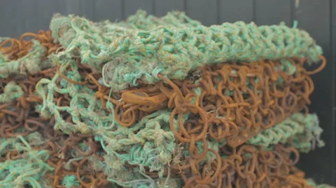 Rustic fishing nets sitting on a Scottish harbour side Stock Footage 58439986