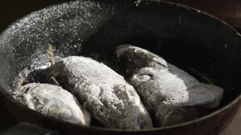 Rustic Fried Fish in Cast-Iron Skillet Stock Footage 303414679