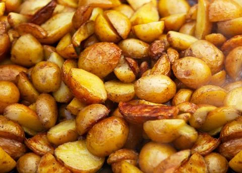 Rustic fried potatoes. Close up background Stock Photos