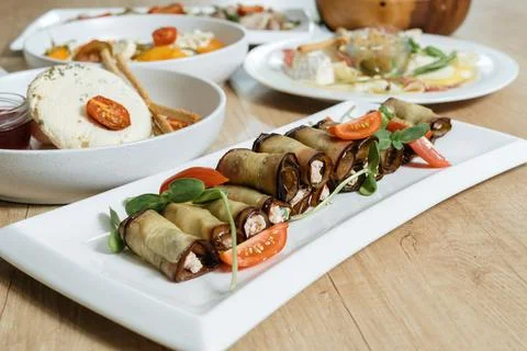 Rustic fried stuffed eggplant with cheese and meat decorated with arugula Фото