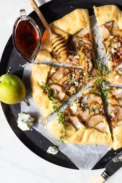 Rustic galette with pears, blue cheese, walnuts and honey. Stock Photos