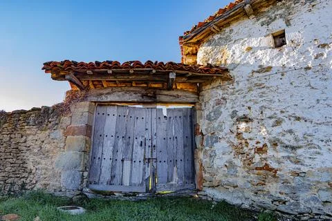 Rustic Gate and Stone Wall in Bright Sunlight Stock Photos