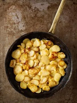 Rustic golden german pan fried potato bratkartofflen Stock Photos