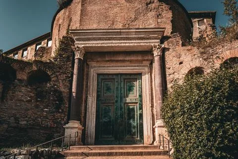 Rustic green door of the Temple wall of Romulus at the Roman Forum in Rome Stock Photos