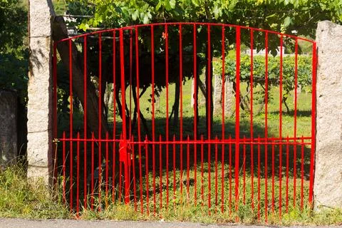 Rustic grille in red field Stock Photos