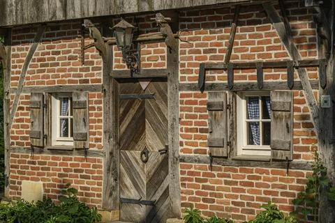 Rustic half-timbered house with striking wooden elements and brick walls, Stock Photos