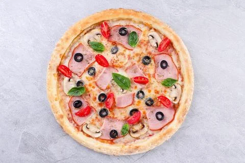 Rustic Ham and Olive Pizza with Cherry Tomatoes and Basil Stock Photos