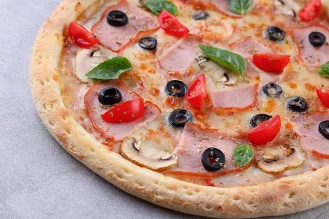 Rustic Ham and Olive Pizza with Cherry Tomatoes and Basil Stock Photos