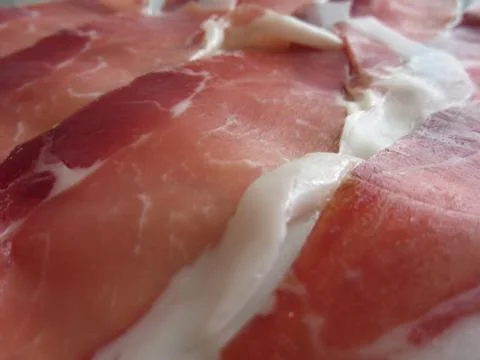 Rustic ham prosciutto as background . Fresh cold cuts from Tuscany, Italy Stock Photos