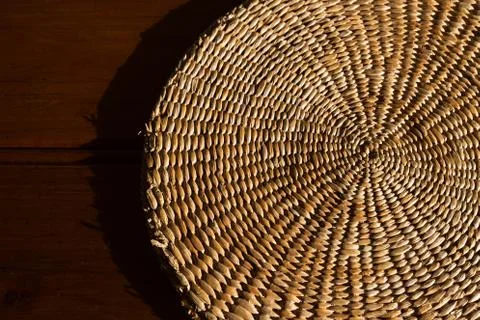 Rustic, hand woven grass wicker mat and authentic timber background Stock Photos