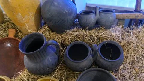 Rustic handmade ceramic clay yellow and black terracotta pots. Rural life con Stock Photos