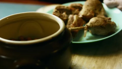 Rustic hands seasoning raw chicken before baking in wide view, 4K Stock Footage 341106884