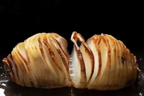 Rustic hasselback baked potatoes Stock Photos