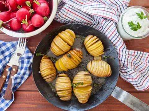 Rustic hasselback potatoes Stock Photos