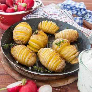Rustic hasselback potatoes Stock Photos