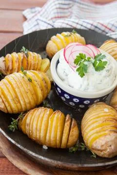 Rustic hasselback potatoes Stock Photos