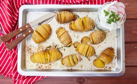 Rustic hasselback potatoes Stock Photos