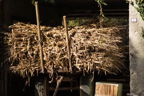 Rustic hay wagon from the past. Rural image of a small historical town in Italy. Stock Photos