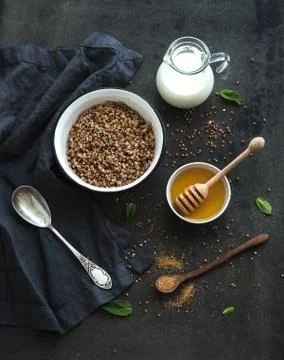 Rustic healthy breakfast set. Cooked buckwheat groats with milk and honey on  Stock Photos
