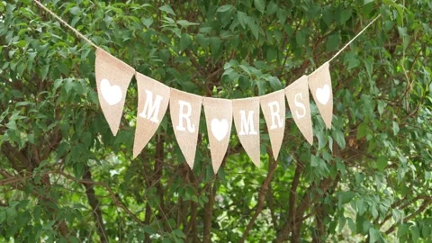 Rustic Hessian Burlap Mr and Mrs Bunting Banner Hanging on Green Leaves Out.. 動画素材 347171517