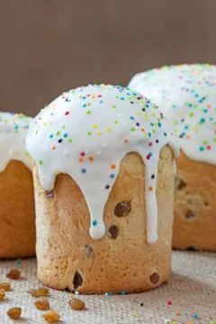 Rustic homemade easter panettone cake called kulich with icing and raisins on Stock Photos