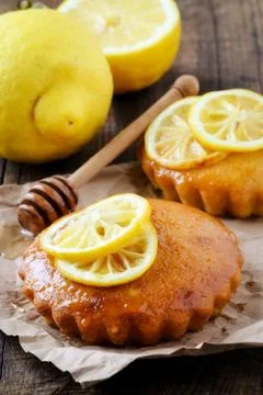 Rustic homemade lemon mini cake with honey glaze decorated with grilled lemon Stock Photos