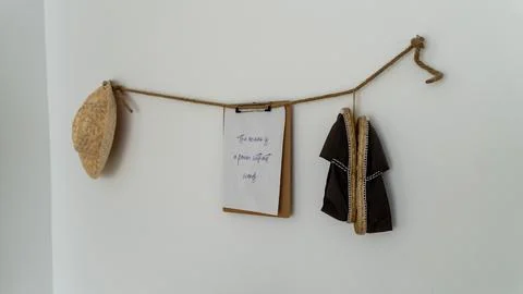 Rustic Hotel Room Wall Decor with Straw Hat and Hanging Sandals Stock Photos