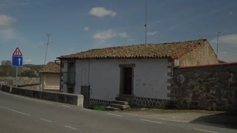 Rustic house along a winding road Stock Footage 335461065