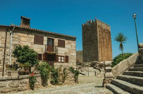 Rustic house and tower behind a stone staircase Stock Photos