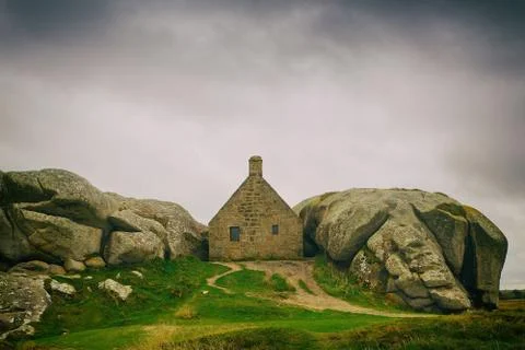 Rustic house built between two large stones, france Stock Photos