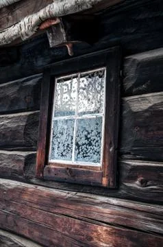 Rustic house with snowflakes on window Stock Photos