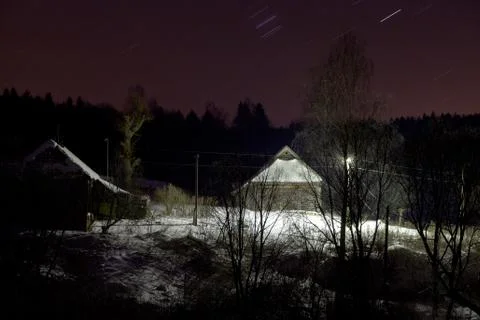 Rustic house under snow at night Stock Photos