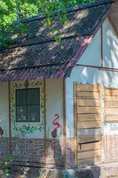 A rustic hut with tropical decor, located in a natural setting possibly imply Stock Photos