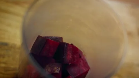 Rustic immersion blender smoothing roasted beetroot in action, 4K Stock Footage 341111382