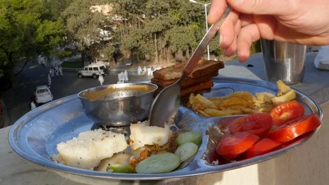 Rustic Indian man cuts down the branches of a palm tree Vidéo 104370235