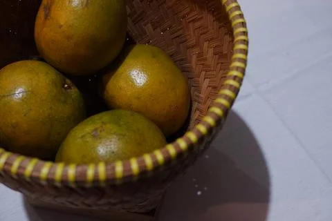 Rustic Indonesian Local Oranges Displayed in Traditional Bamboo Basket Stock Photos