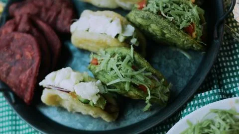 Rustic ingredient study: adding creamy pickle sauce to a lettuce wrap Stock Photos