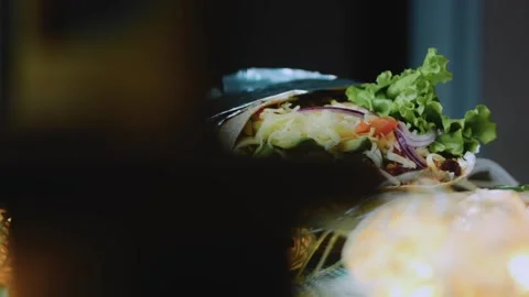 Rustic ingredient view: cutting a burrito to reveal its layers Stock Footage 342168254