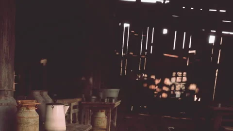 Rustic Interior of a Barn With Warm Light and Vintage Farm Equipment Stock Footage 344951972