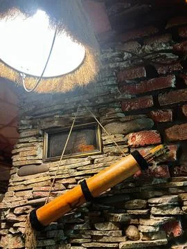 Rustic interior decor with brick wall and unique hanging wooden bow arrows .. Stock Photos