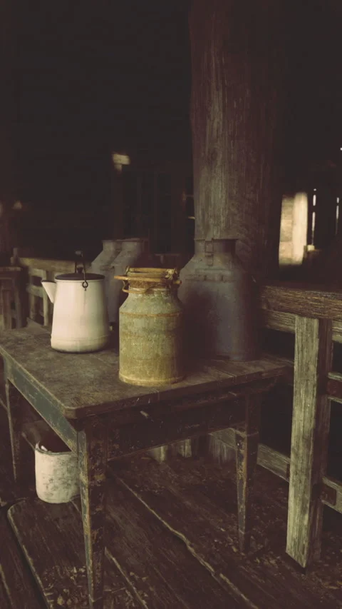 Rustic interior of an old barn showcasing vintage pottery and wooden furniture Stock Footage 325076545