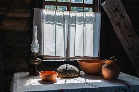 Rustic interior with a window bathed in sunlight. The room is dimly lit, bu.. Stock Photos