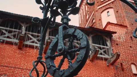 Rustic iron wheel against brick castle wall Stock Footage 301124690