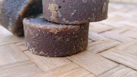 Rustic Jaggery Blocks and Crushed Sugar on Bamboo Matting Stock Footage 341456396