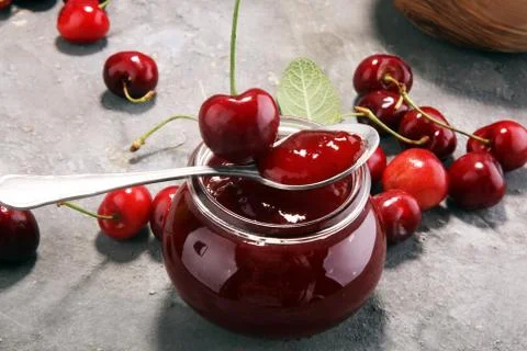 Rustic jar with cherry jam and fresh cherries, homemade preserves Stock Photos