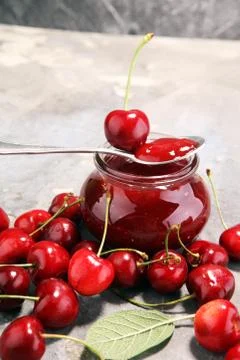 Rustic jar with cherry jam and fresh cherries, homemade preserves Stock Photos