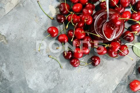 Rustic jar with cherry jam and fresh cherries, homemade preserves Stock Photos